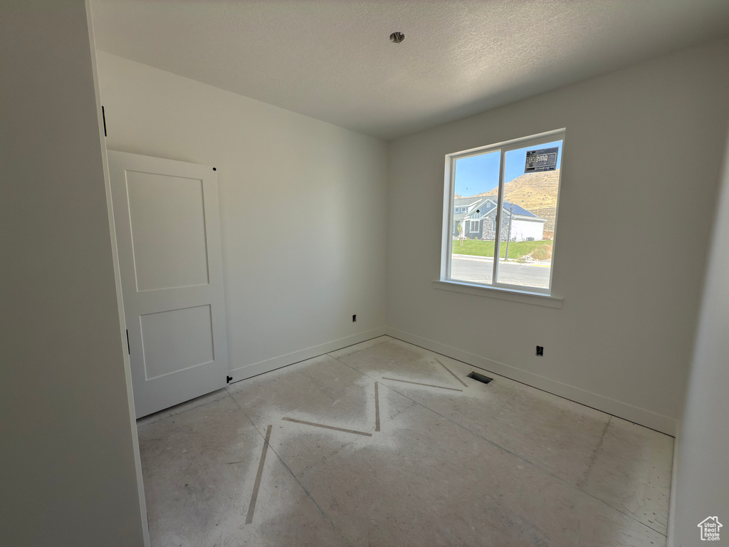 Empty room with a textured ceiling