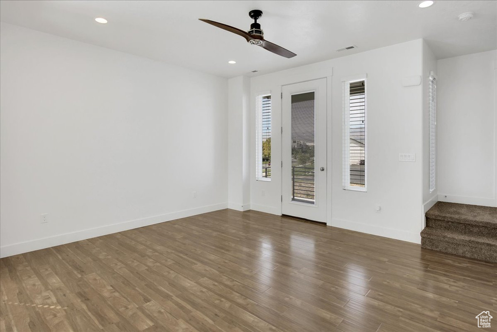 Interior space with dark hardwood / wood-style flooring and ceiling fan