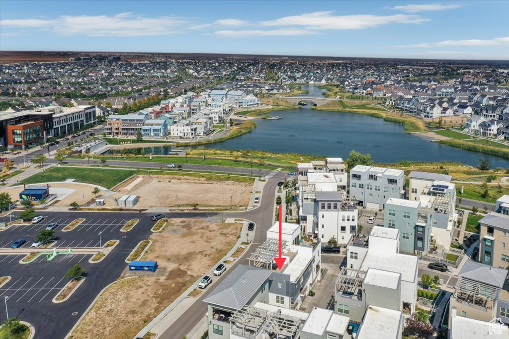 Birds eye view of property with a water view