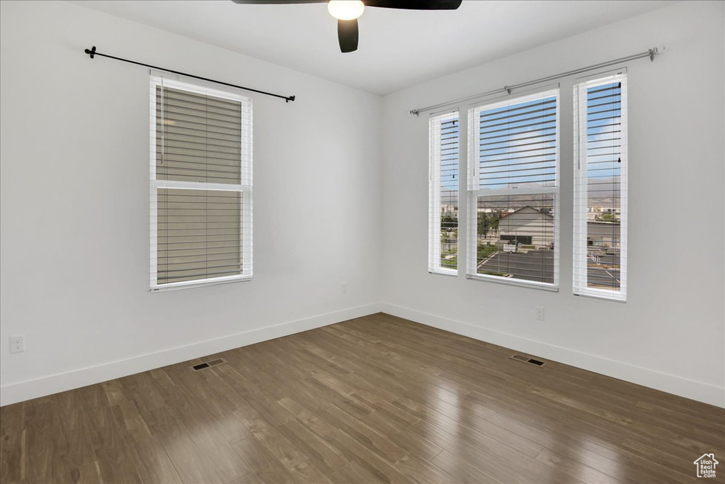 Spare room with ceiling fan and dark hardwood / wood-style flooring