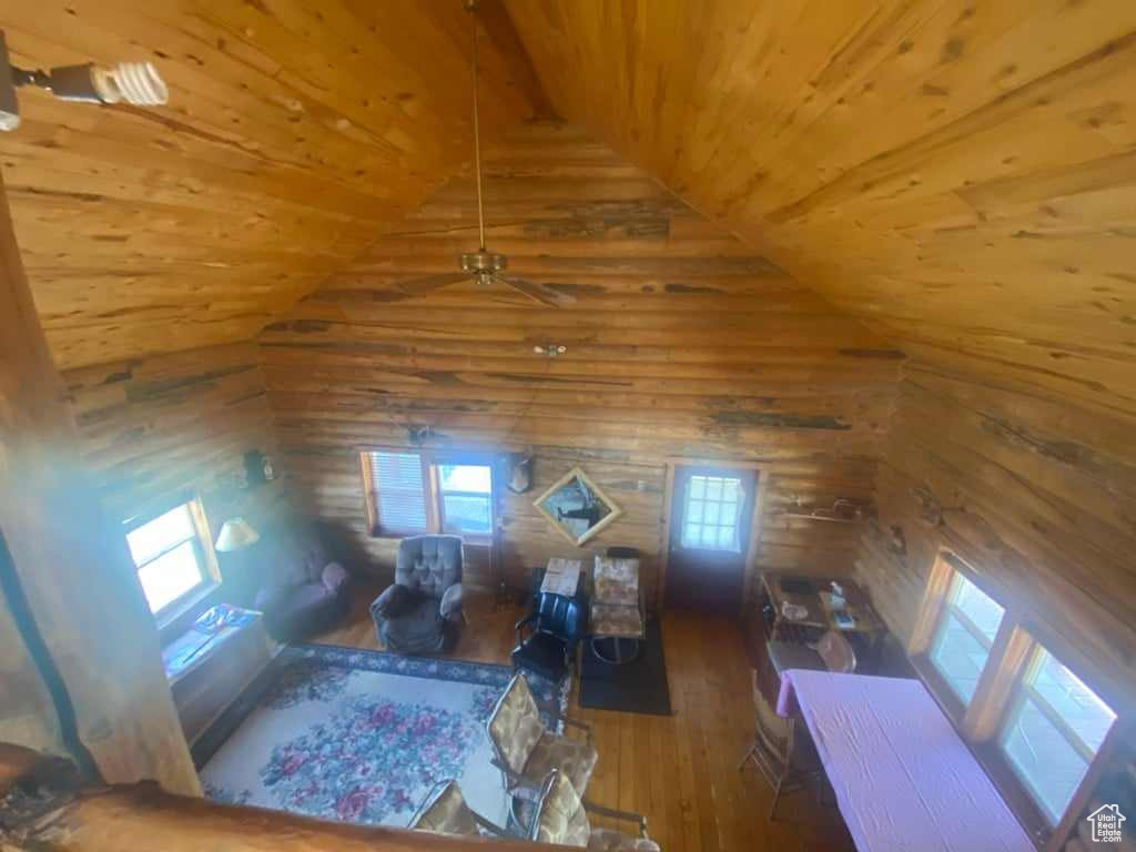 Living room with lofted ceiling, ceiling fan, wood-type flooring, and wooden ceiling