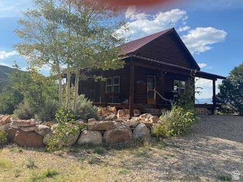 View of property exterior featuring covered porch