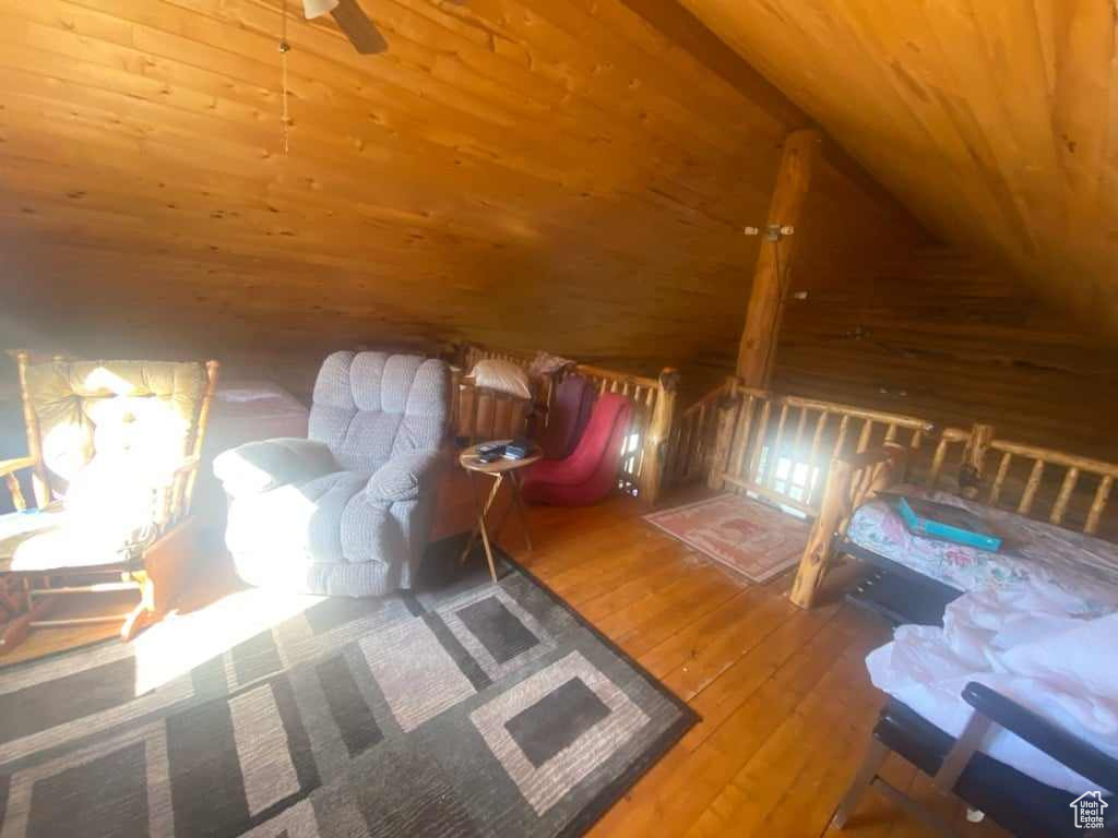 Interior space with lofted ceiling, hardwood / wood-style floors, and wood ceiling