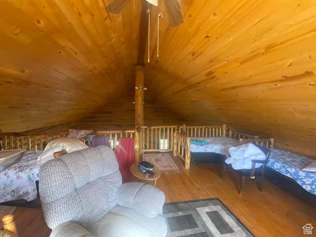 Unfurnished bedroom featuring lofted ceiling, hardwood / wood-style floors, and wooden ceiling