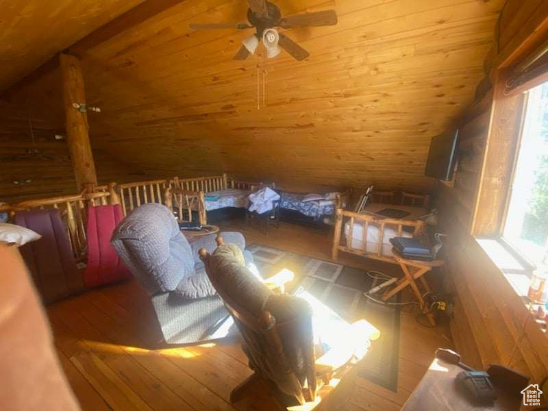 Interior space featuring wooden ceiling, multiple windows, vaulted ceiling, and hardwood / wood-style flooring