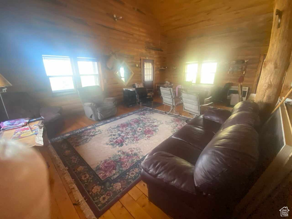 Living room featuring hardwood / wood-style flooring and wood walls