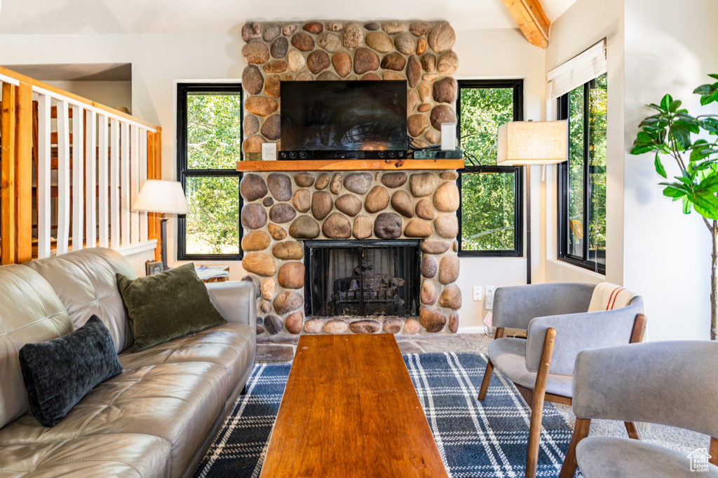 Living room with beam ceiling and a fireplace