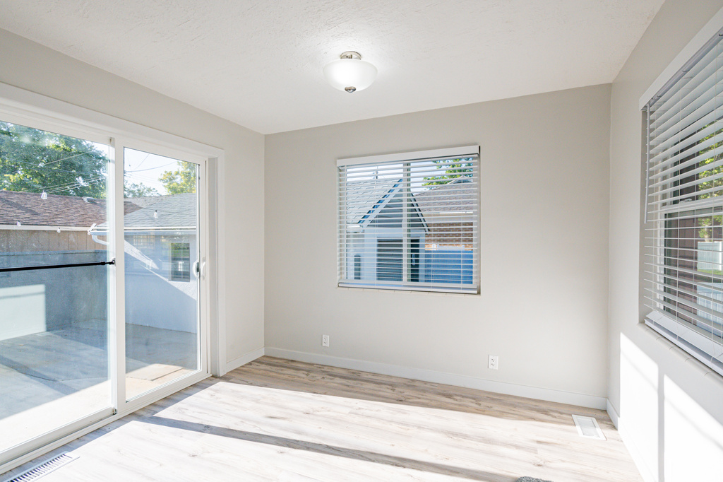 Empty room with light hardwood / wood-style floors