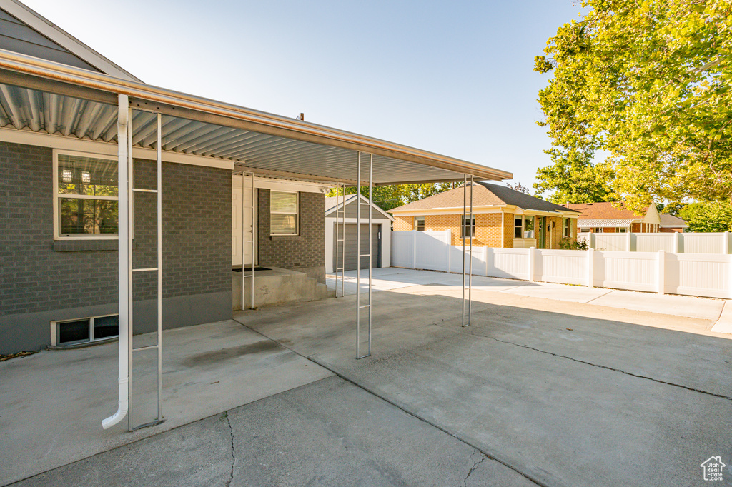 View of patio / terrace featuring an outdoor structure and a garage