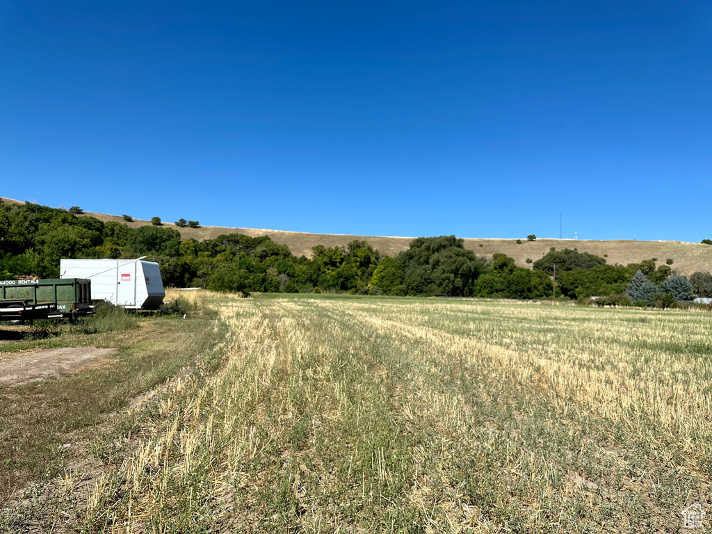 View of yard with an outdoor structure and a rural view