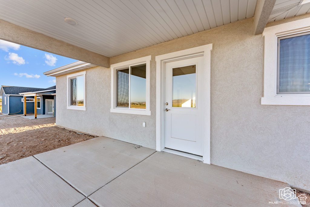 Doorway to property with a patio area