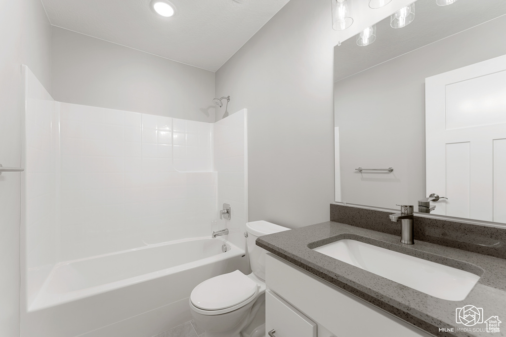 Full bathroom featuring  shower combination, vanity, and toilet