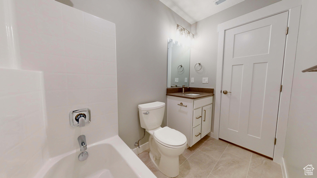 Bathroom with vanity, toilet, and tile patterned floors