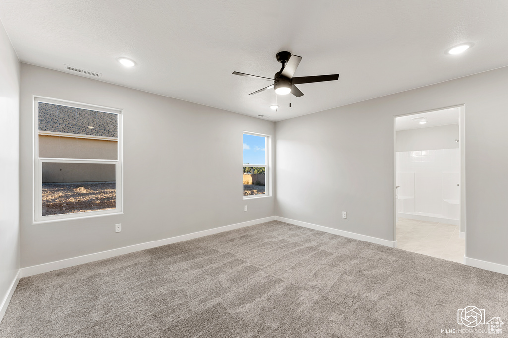 Carpeted empty room with ceiling fan