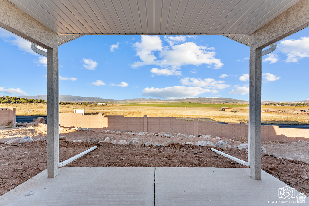 View of patio / terrace featuring a mountain view and a rural view