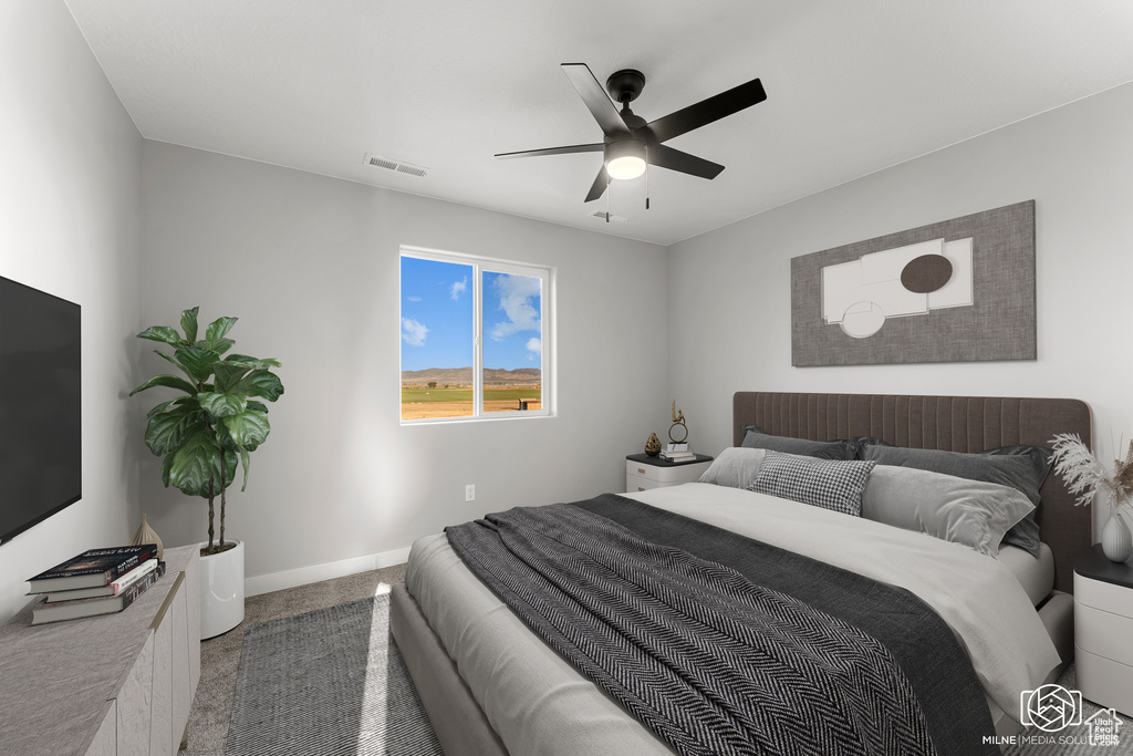 Carpeted bedroom with ceiling fan