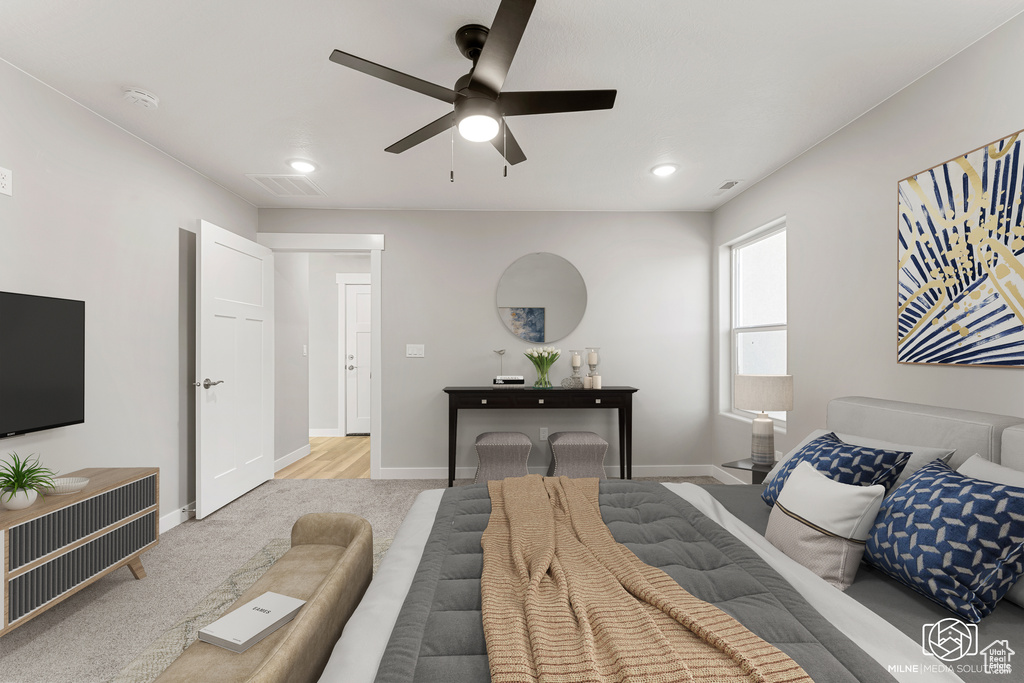 Carpeted bedroom with ceiling fan