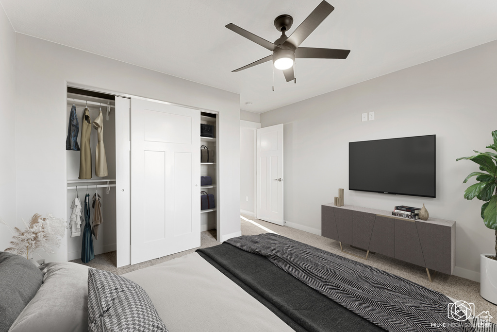 Bedroom with ceiling fan, light colored carpet, and a closet