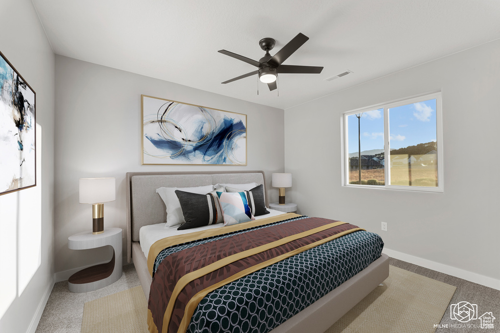 Carpeted bedroom with ceiling fan