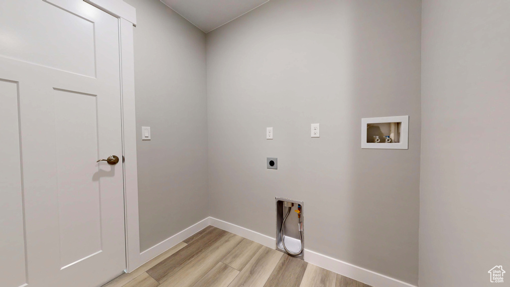 Laundry room featuring washer hookup, light hardwood / wood-style flooring, and electric dryer hookup