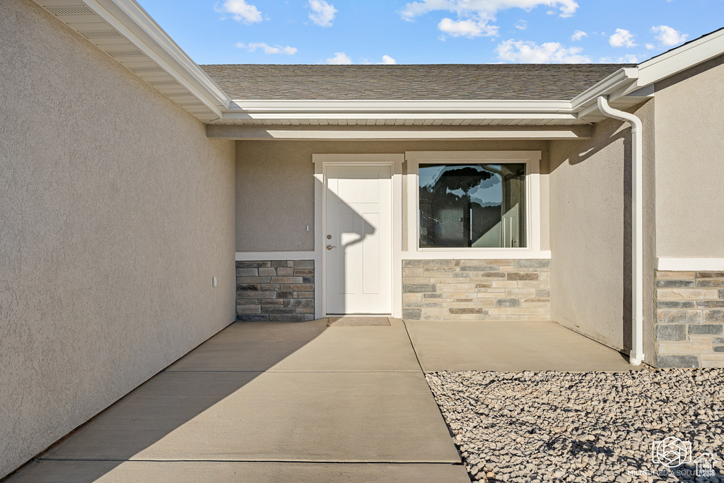 Doorway to property with a patio area