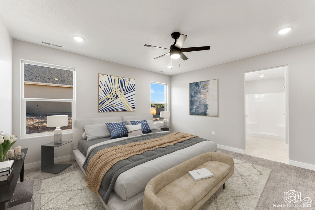 Carpeted bedroom with connected bathroom and ceiling fan