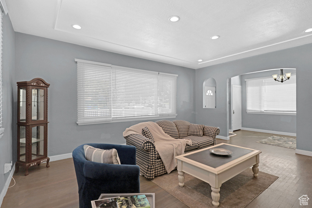 Living room featuring hardwood / wood-style flooring and an inviting chandelier