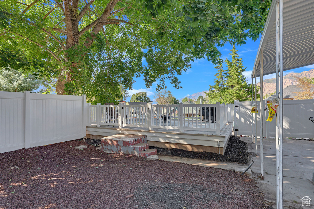 View of yard with a wooden deck