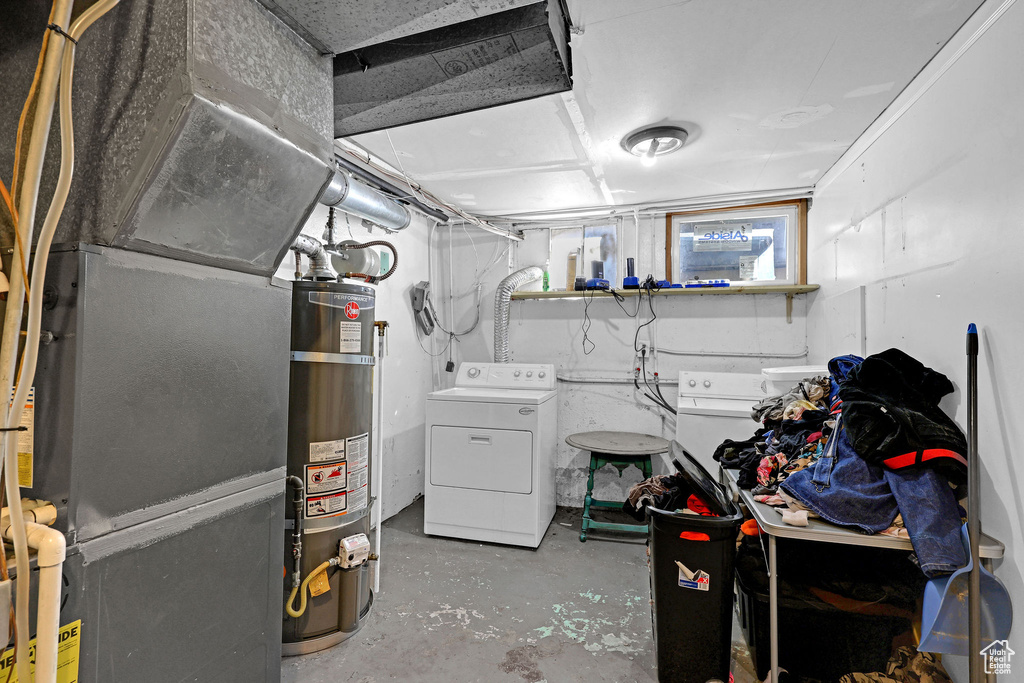 Basement featuring washer / clothes dryer and strapped water heater