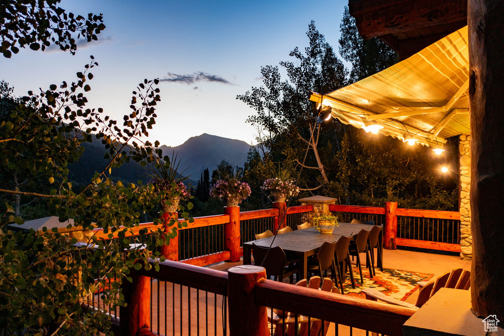 Deck at dusk featuring a mountain view