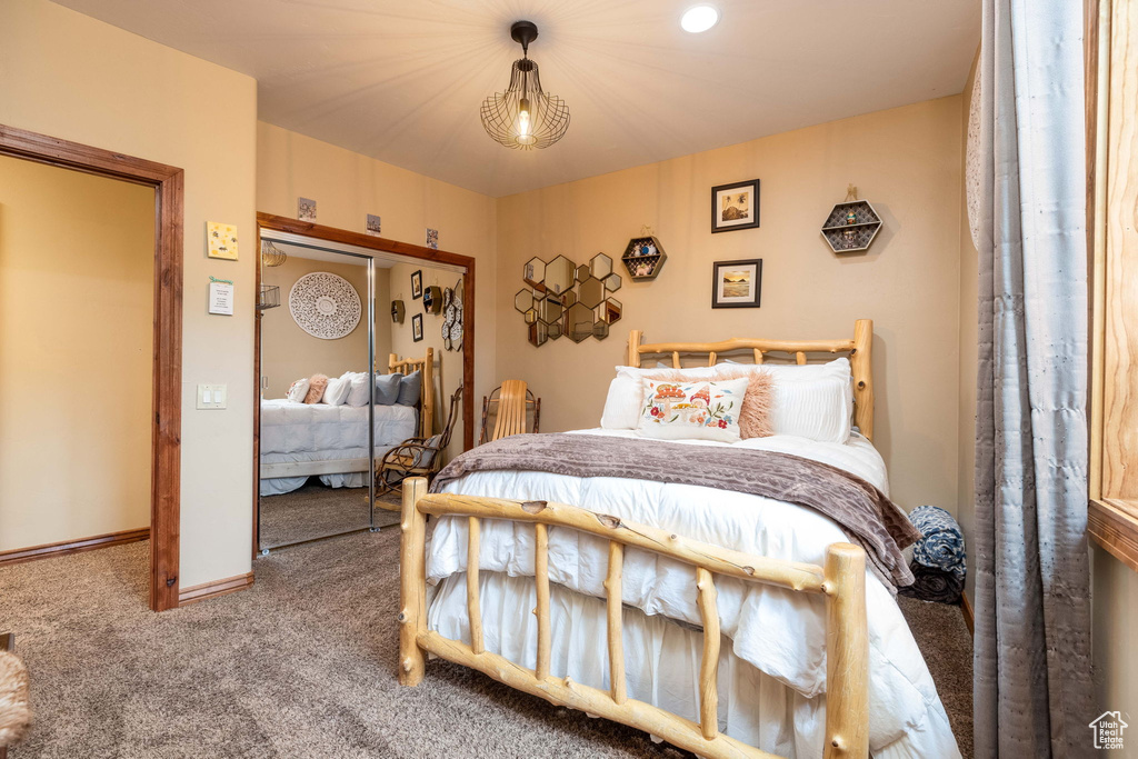 Carpeted bedroom featuring a closet