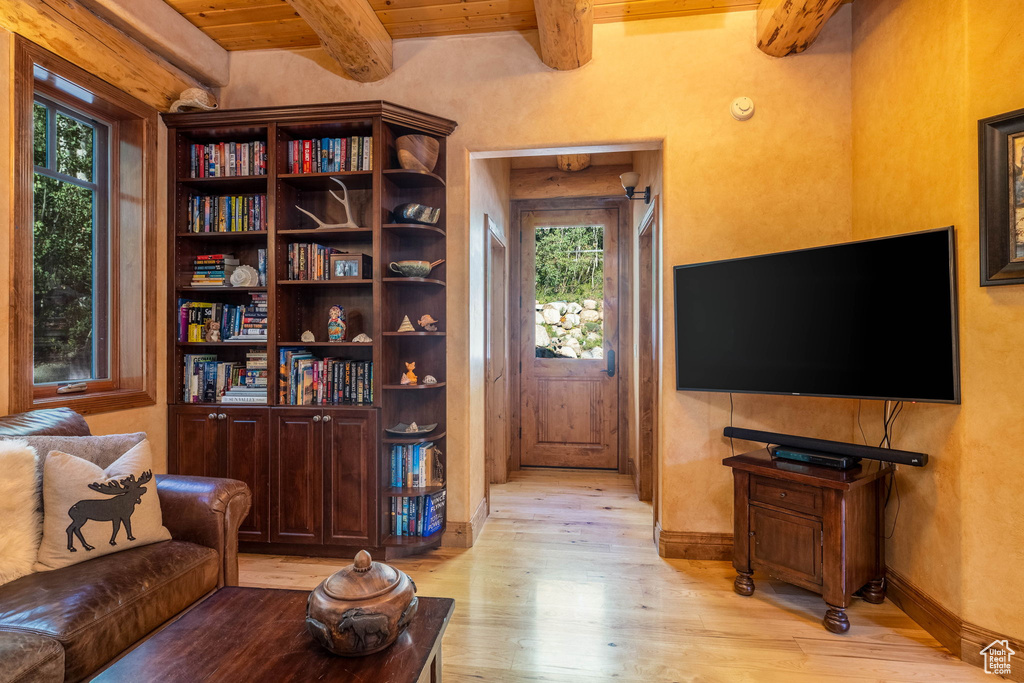 Interior space featuring light wood-type flooring, beamed ceiling, and wooden ceiling