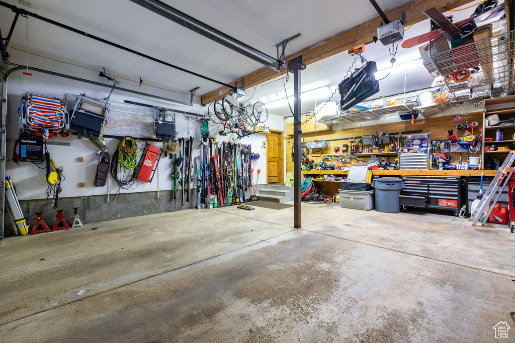 Garage featuring a workshop area and a garage door opener