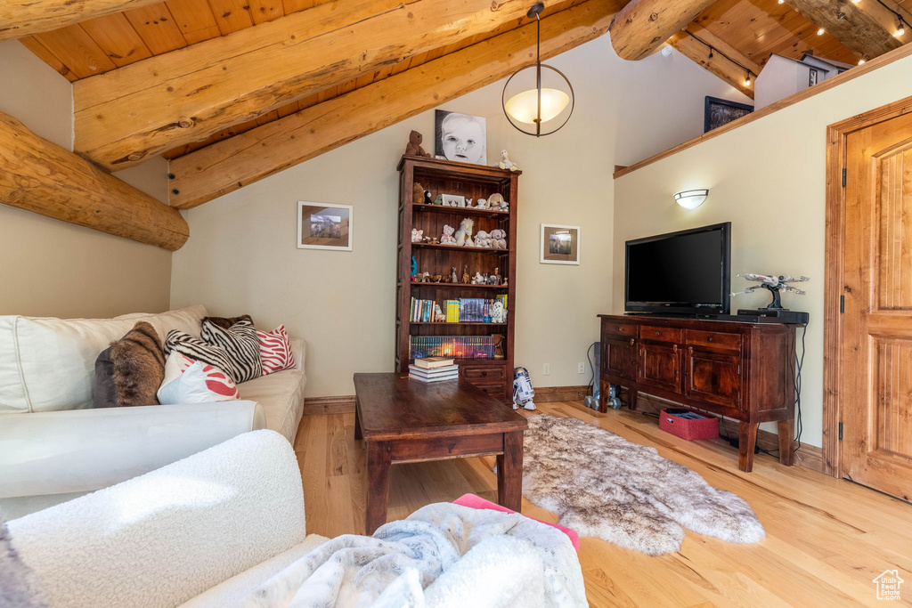 Living room with wood-type flooring, wooden ceiling, and lofted ceiling with beams