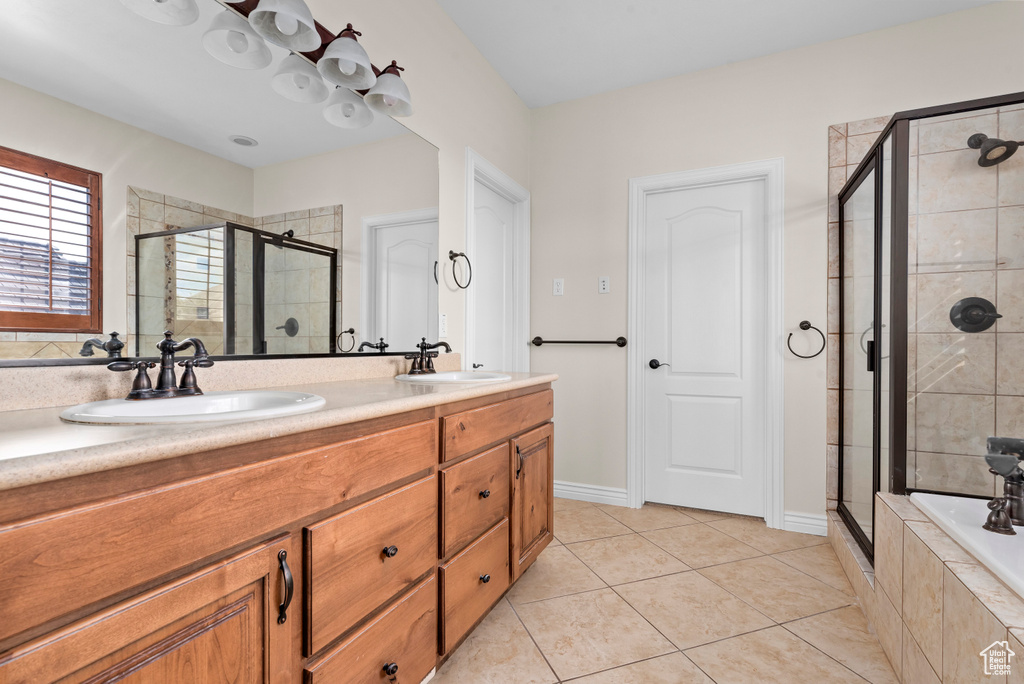 Bathroom with vanity, separate shower and tub, and tile patterned floors