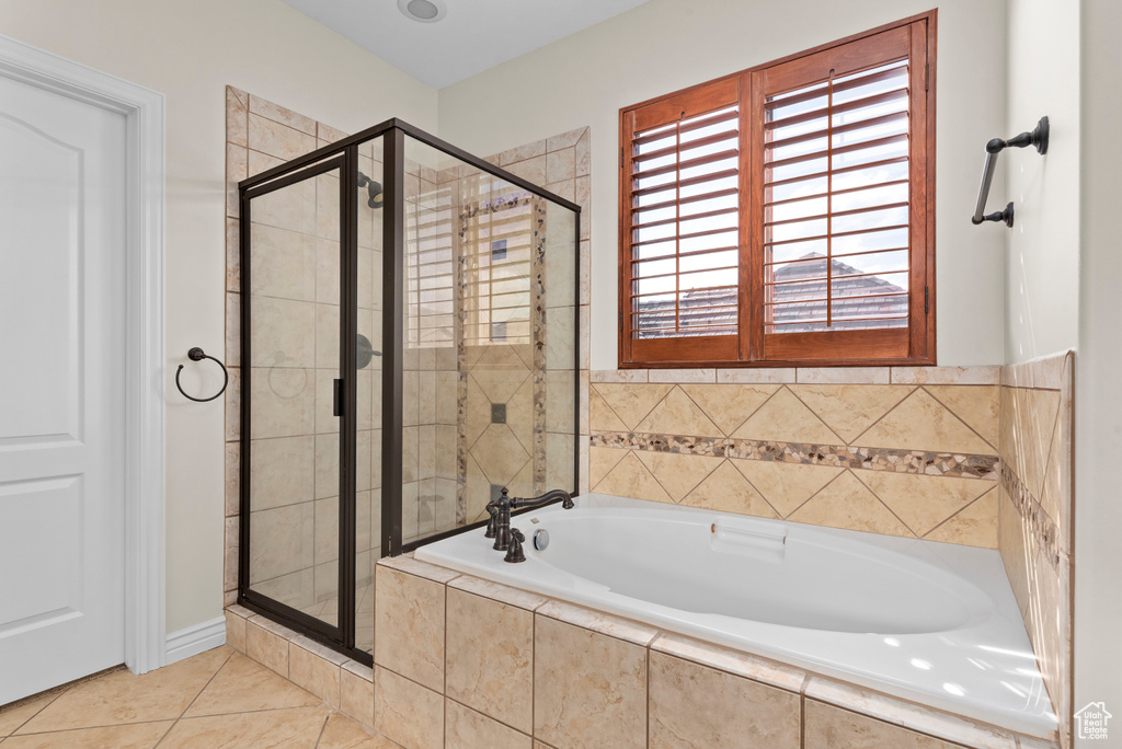 Bathroom featuring independent shower and bath and tile patterned flooring