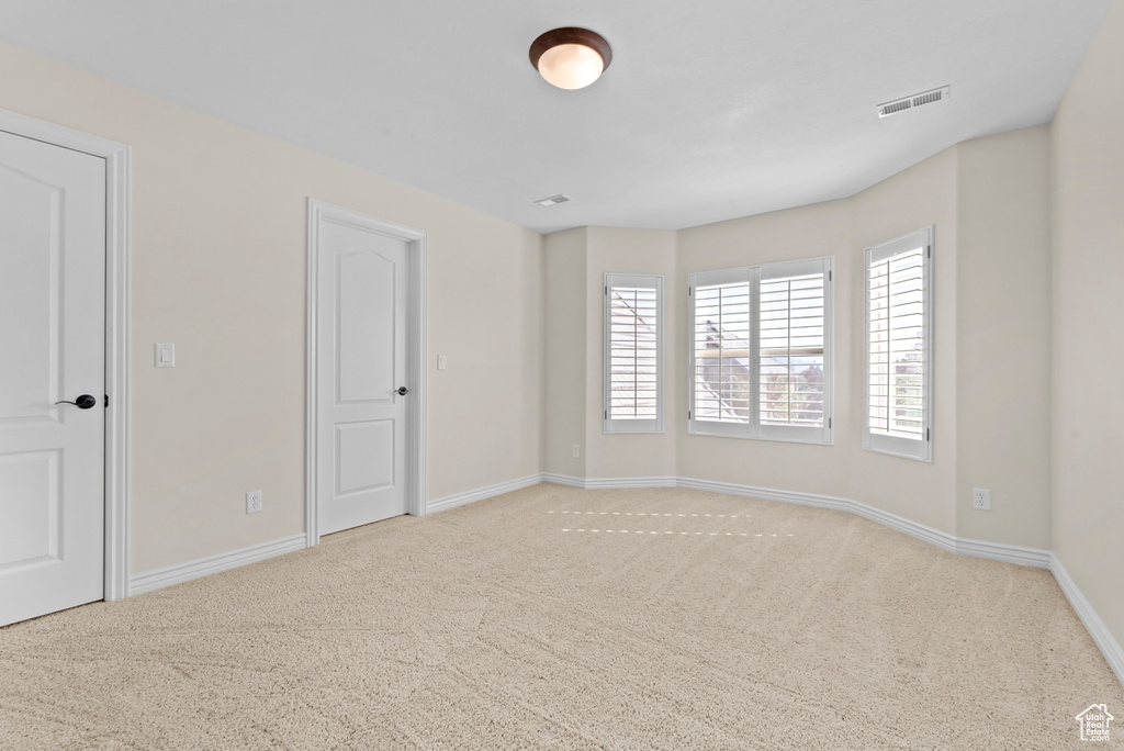 Spare room featuring light colored carpet