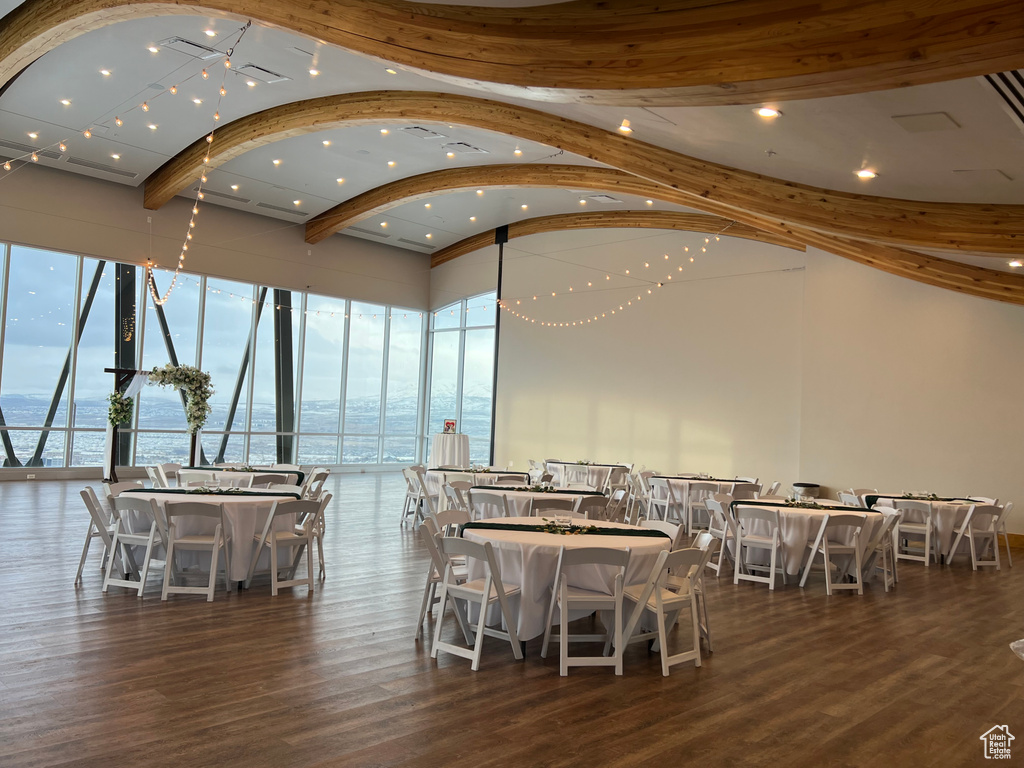 Dining room featuring a water view and dark hardwood / wood-style floors