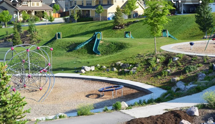 View of home's community featuring a lawn and a playground