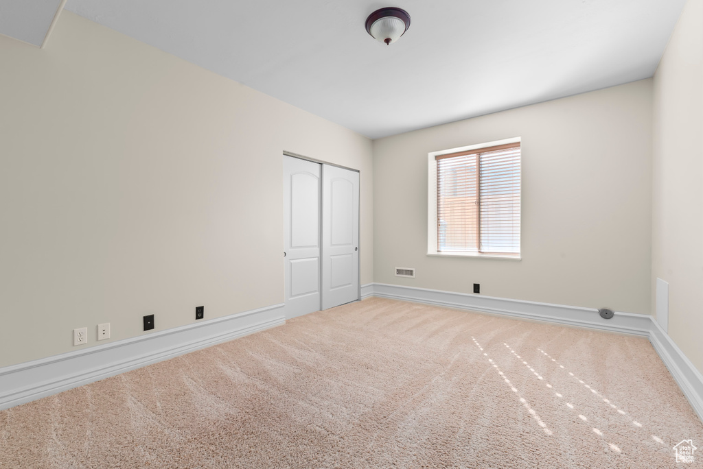 Unfurnished bedroom with carpet floors and a closet