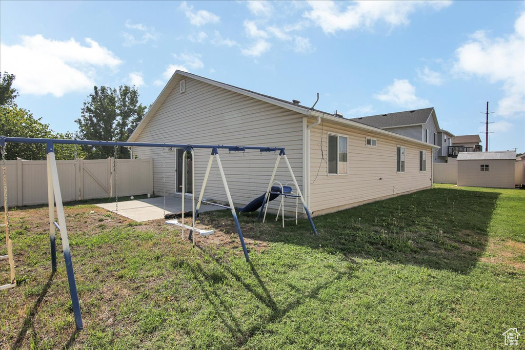 Back of property featuring a patio area and a lawn
