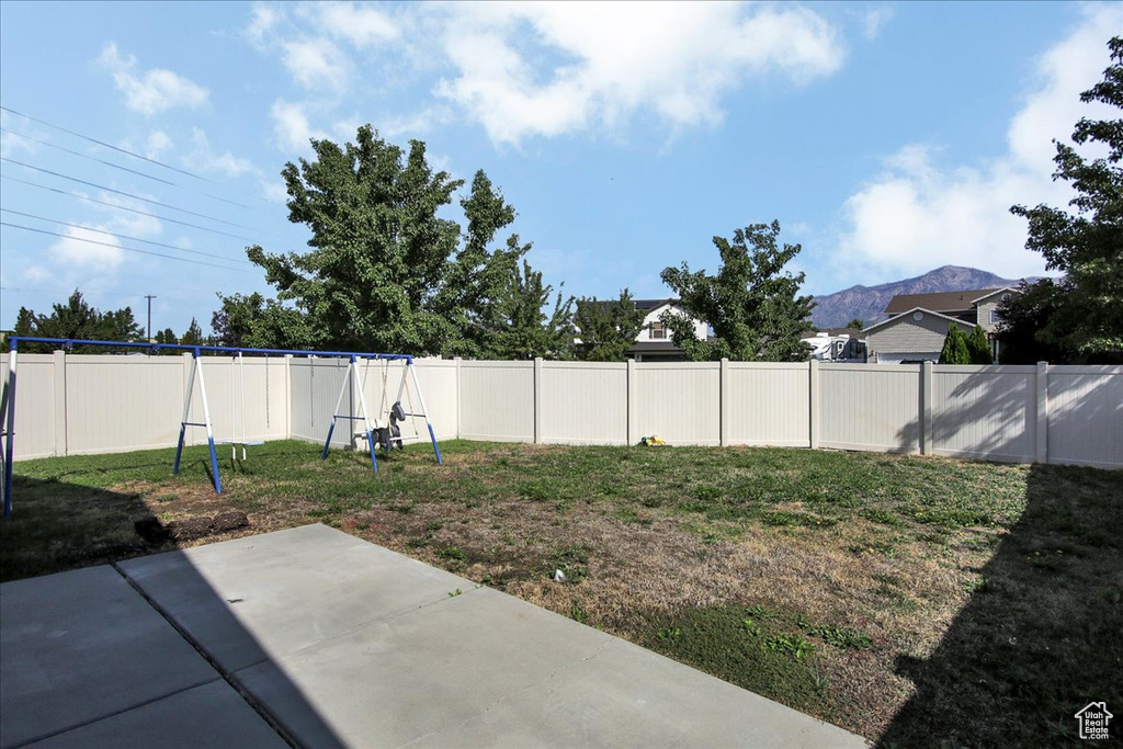 View of yard with a mountain view and a patio area