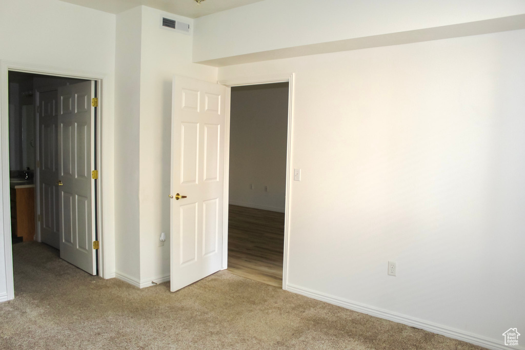 Empty room featuring light carpet