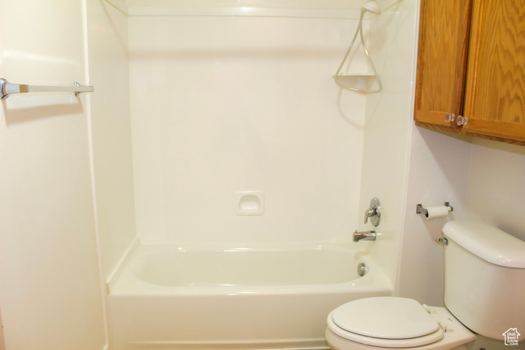 Bathroom featuring bathing tub / shower combination and toilet