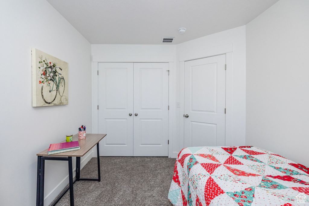 Carpeted bedroom featuring a closet