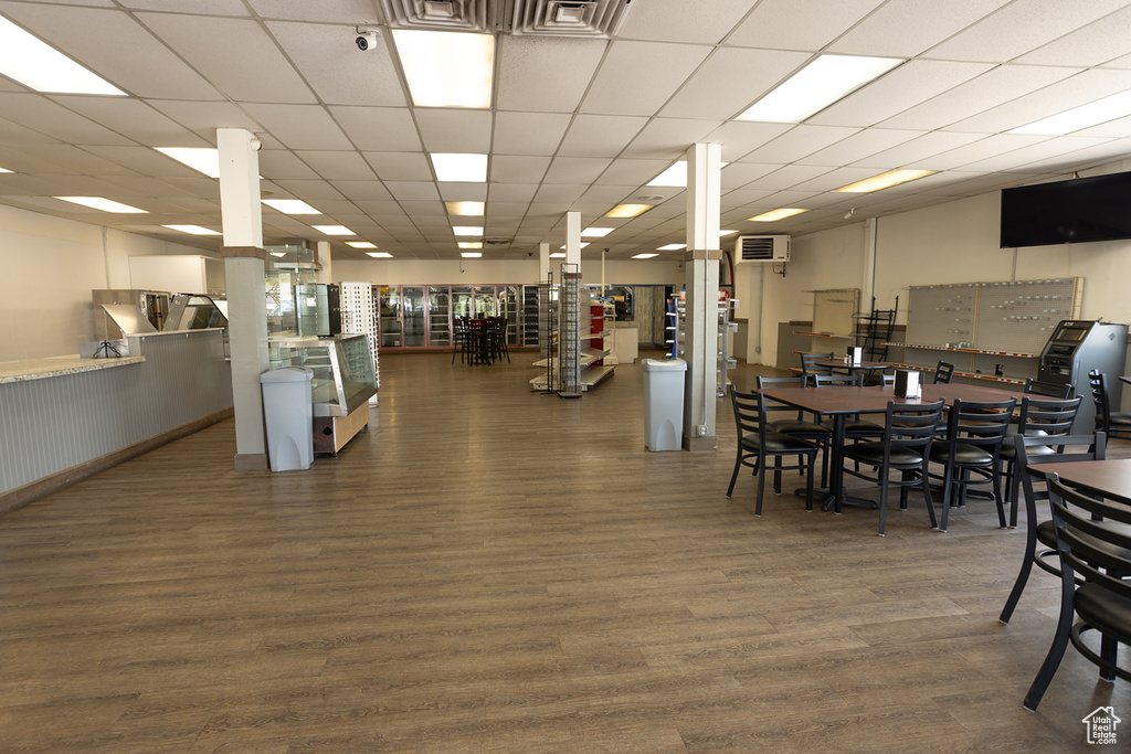 Dining space featuring a paneled ceiling and dark hardwood / wood-style flooring