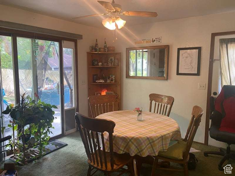 Dining room with plenty of natural light, carpet, and ceiling fan