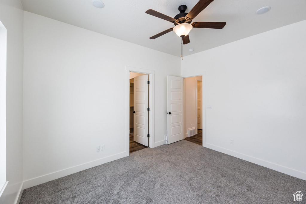 Interior space featuring ceiling fan and carpet floors