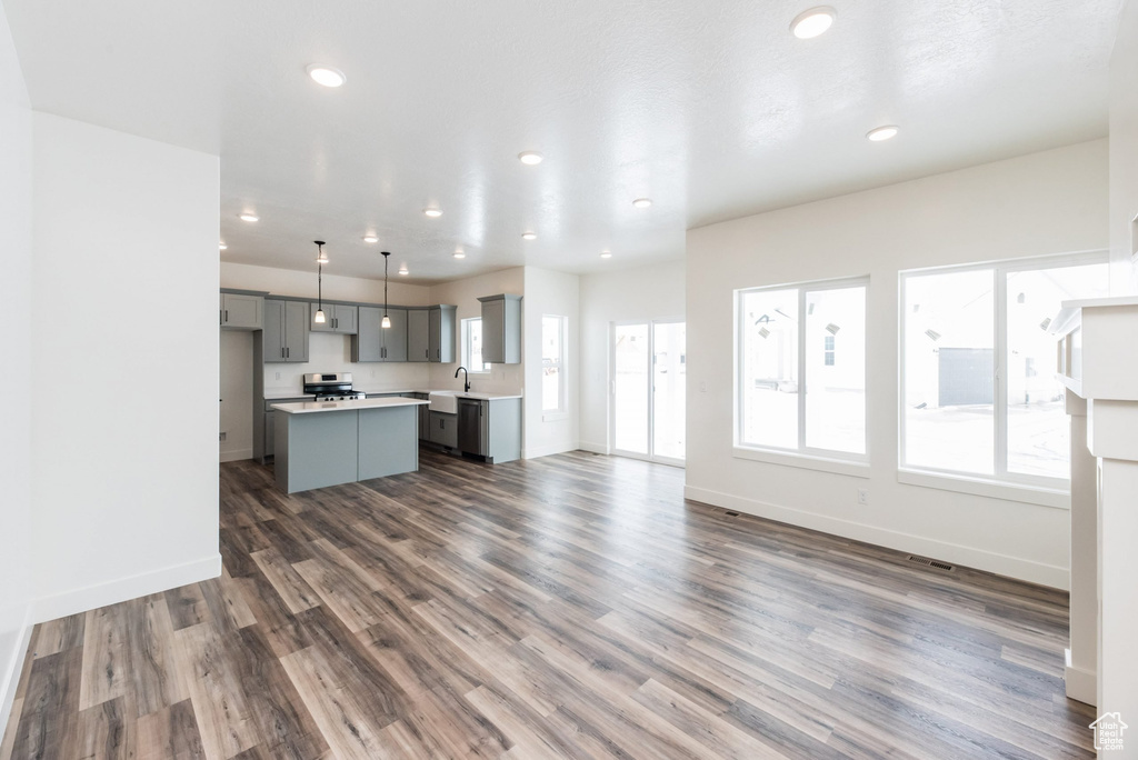 Unfurnished living room featuring dark wood-type flooring