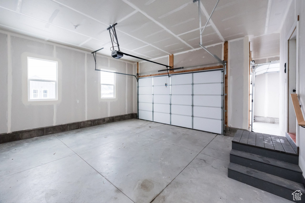 Garage featuring a garage door opener